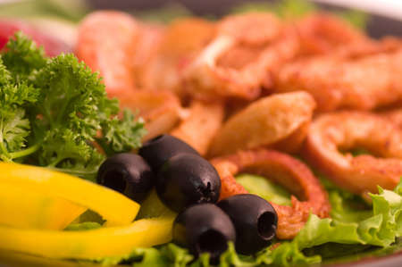 Tasty deep fried squid rings with vegetablesの写真素材