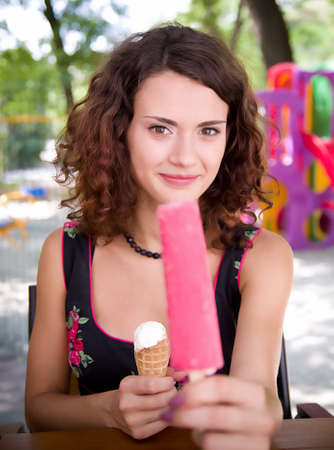 Beautiful woman holding pink ice creamの写真素材
