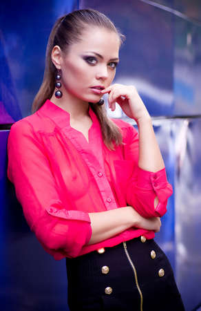 Beautiful young woman in fashion clothes