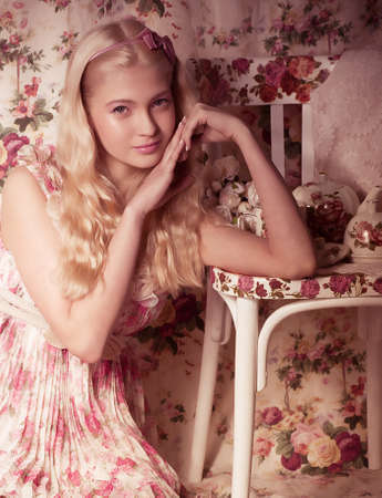 Young girl in pink dress on background 