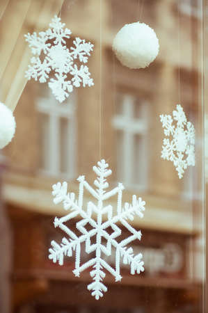 Christmas decorations snowflakes in windowの写真素材