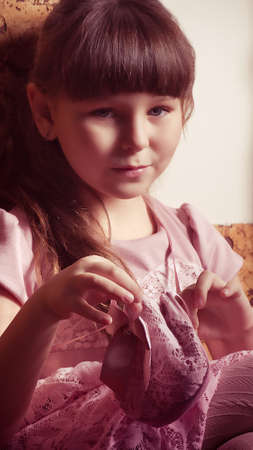 Beautiful little girl in pink dress in vintage styleの写真素材