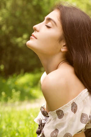 Beautiful young woman in spring gardenの写真素材