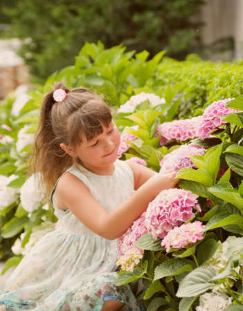 little happy girl in gardenの写真素材