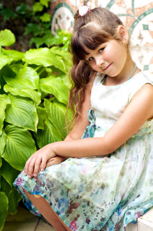 little happy girl in gardenの写真素材