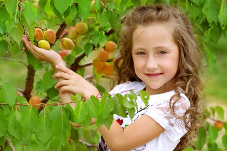 little happy girl in gardenの写真素材