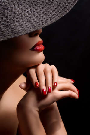 Portrait of beautiful young woman with makeup in black hatの写真素材