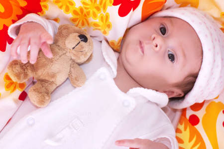 Cute funny infant baby with toy bear
