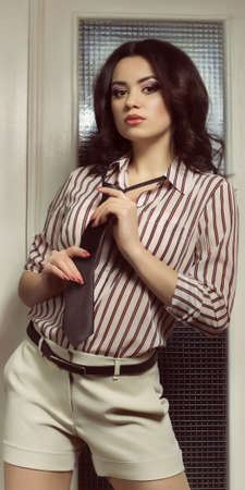 Portrait of beautiful young woman with makeup in fashion clothesの写真素材