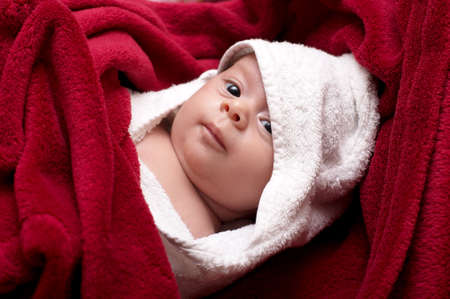 Beautiful baby in towel after bathingの写真素材