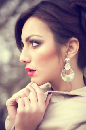 Portrait of beautiful young woman with makeup and with jewelry precious decorations の写真素材