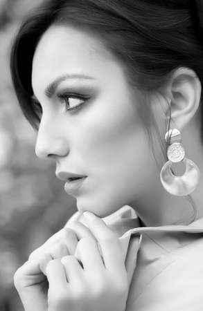 Portrait of beautiful young woman with makeup and with jewelry precious decorations の写真素材