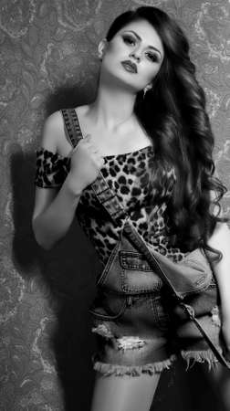Portrait of beautiful young woman with makeup in fashion clothes