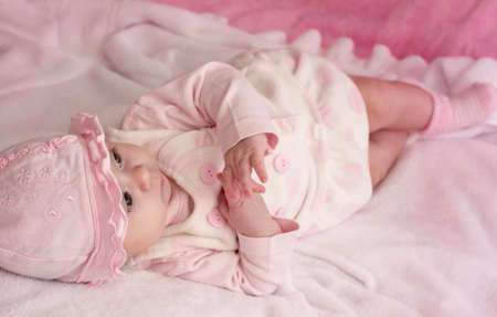 Beautiful baby girl on pink background