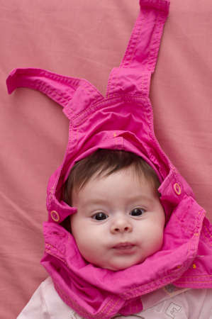 Beautiful baby girl on pink background