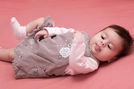 Beautiful baby girl on pink background