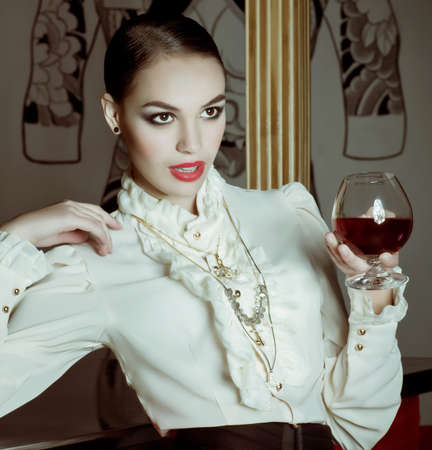 Portrait of beautiful young girl with wine glassの写真素材
