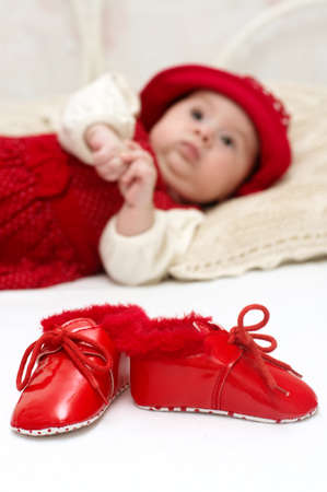 Cute baby girl in red hatの写真素材