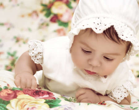 Cute little girl in dress and hatの写真素材