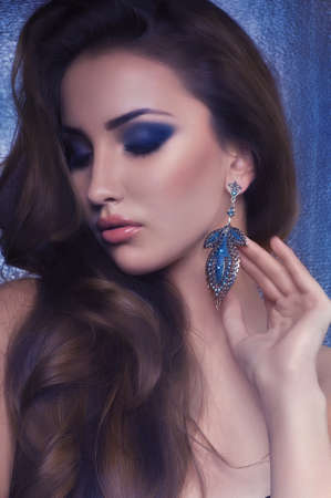 Portrait of beautiful young woman with makeup and precious decorationsの写真素材