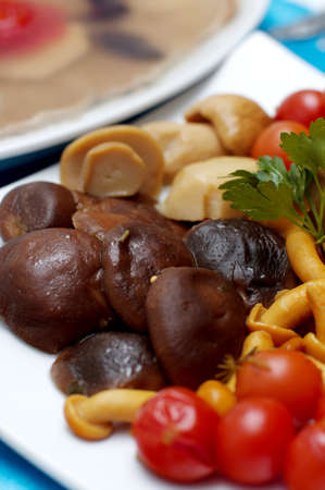 Pickled vegetables and mushrooms on a festive tableの写真素材
