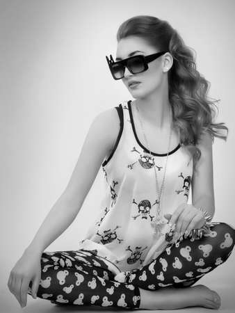 Portrait of beautiful young woman with makeup in fashion clothesの写真素材