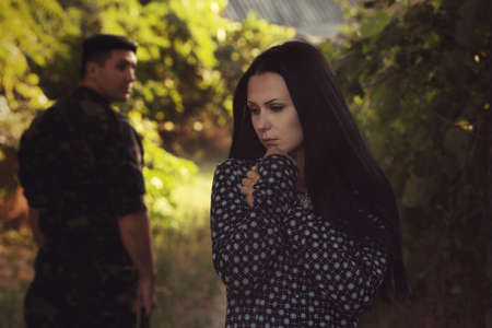 Woman and soldier in a military uniform say goodbye before a separationの写真素材