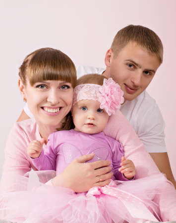 Young happy mother and father with baby girlの写真素材