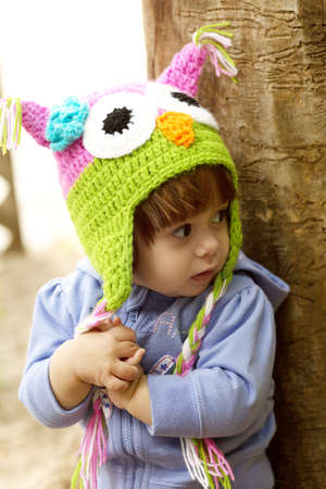 Beautiful baby girl is in the little cap of owlの写真素材