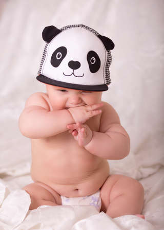 Little baby boy wearing a panda cap.の写真素材