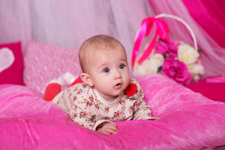 Beautiful baby girl on pink backgroundの写真素材