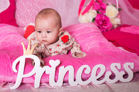 Beautiful baby girl on pink backgroundの写真素材