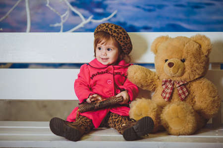 Cute funny baby girl with toy bearの写真素材