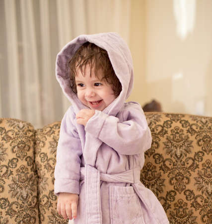 Baby girl in a plush bathrobeの写真素材