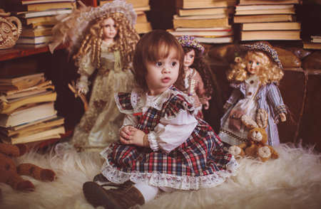 Cute charming little lady with dolls. Retro style.の写真素材