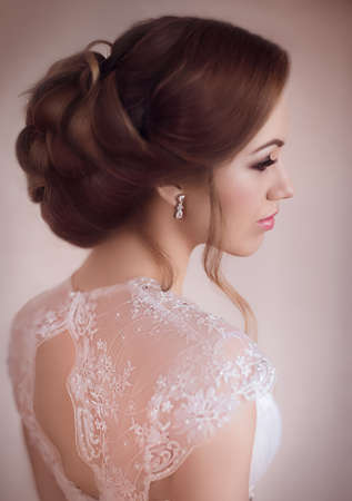Beautiful bride with stylish make-up in white dress