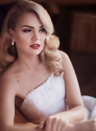 Beautiful bride with stylish make-up in white dressの写真素材