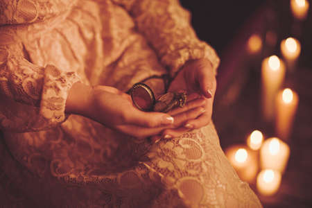 Young woman with retro clock in hands
