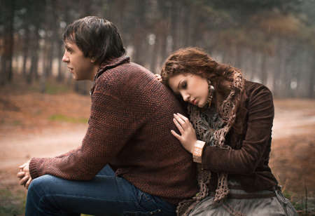 Young couple laying on park lawn