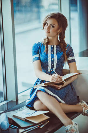 Portrait of beautiful young woman with makeup in fashion clothesの写真素材