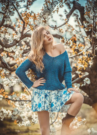 Beautiful young woman in spring garden
