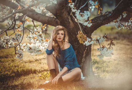 Beautiful young woman in spring gardenの写真素材