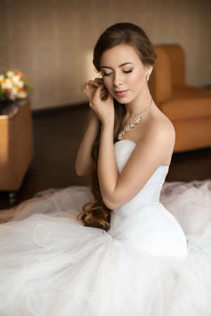 Beautiful bride with stylish make-up in white dressの写真素材