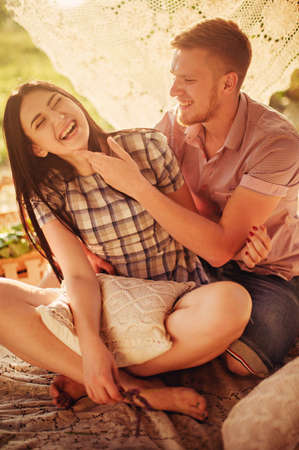 Young couple in love on park lawnの写真素材