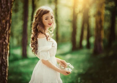 Beautiful young woman in spring gardenの写真素材