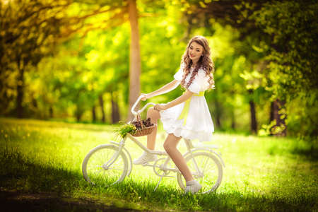 Beautiful young woman in spring gardenの写真素材