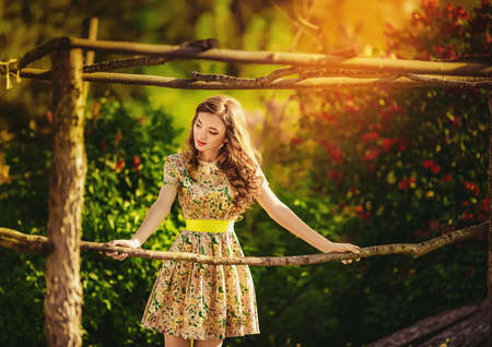 Beautiful young woman in spring gardenの写真素材