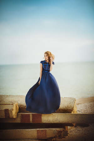 Beautiful young girl on a sea-shoreの写真素材