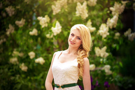Beautiful young woman in spring gardenの写真素材