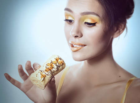 Beautiful fashion girl with delicious orange praline